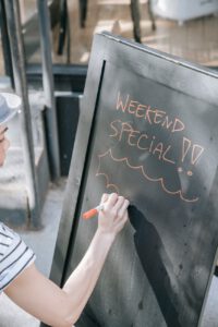 a person writing on the chalkboard